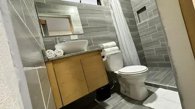 a small bathroom with a toilet and a sink at Nomada Monteverde in Monteverde Costa Rica