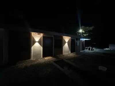 a building with lights on the side of it at night at Tortuguero7 lake view in Tortuguero