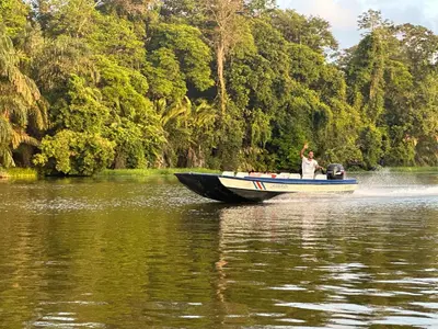 a woman in a boat on a river at Tortuguero7 lake view in Tortuguero