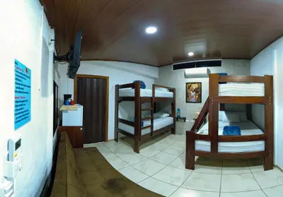 a room with three bunk beds in a house at Tortuguero7 lake view in Tortuguero