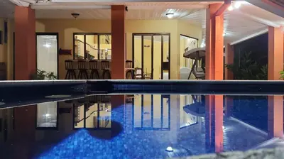 a swimming pool in the middle of a house at CASA DE PLAYA CON PISCINA EN PUNTA LEONA in Puntarenas