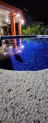 a swimming pool with blue water in a house at CASA DE PLAYA CON PISCINA EN PUNTA LEONA in Puntarenas