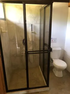 a bathroom with a shower and a toilet at The Elements Costa Rica Nature Lodges in Platanillo