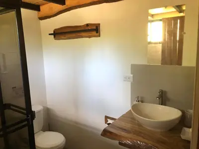 a bathroom with a sink and a toilet at The Elements Costa Rica Nature Lodges in Platanillo