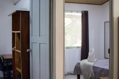 a door leading to a room with a table at Leidy Mar Apartments in Santa Teresa Beach