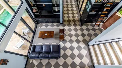an overhead view of a living room with black leather seats at Nostalgic Retro Home on Luxurious Lot with a Private Infinity Pool and Ocean Views in Santa Cruz