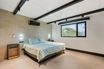a bedroom with a bed and a window at Nostalgic Retro Home on Luxurious Lot with a Private Infinity Pool and Ocean Views in Santa Cruz