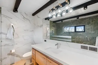 a bathroom with a sink and a mirror at Nostalgic Retro Home on Luxurious Lot with a Private Infinity Pool and Ocean Views in Santa Cruz