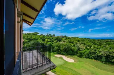 a balcony with a view of a golf course at Stunning Luxury Penthouse in Exclusive Beachfront Community with Resort-Style Amenities & Sweeping Views of the Ocean & Golf Course in Santa Cruz