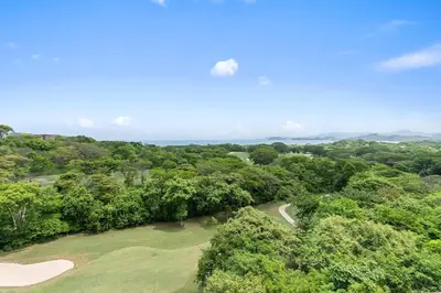an overhead view of a golf course with trees at Stunning Luxury Penthouse in Exclusive Beachfront Community with Resort-Style Amenities & Sweeping Views of the Ocean & Golf Course in Santa Cruz