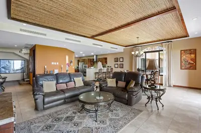 a living room with a couch and a table at Stunning Luxury Penthouse in Exclusive Beachfront Community with Resort-Style Amenities & Sweeping Views of the Ocean & Golf Course in Santa Cruz