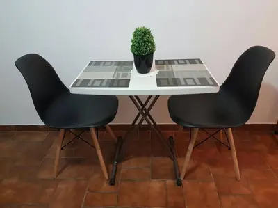 a table with two chairs and a potted plant on it at Hermosa Habitación privada en la Sabana, San Jose in San José