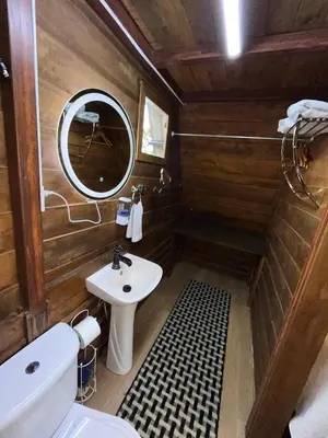 a bathroom with a sink and a mirror at Chalets Vistas del Poas in Heredia