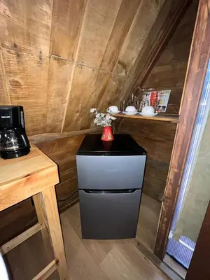 a small kitchen with a black and white refrigerator at Chalets Vistas del Poas in Heredia