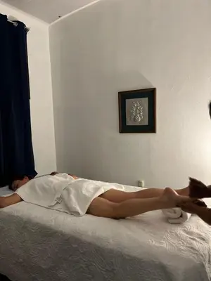 a woman laying on top of a bed at La posada de nana in Alajuela City