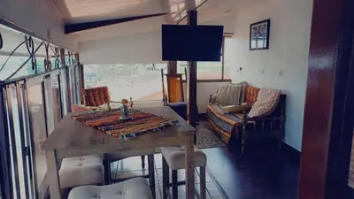 a living room with a wooden table and a couch at La posada de nana in Alajuela City