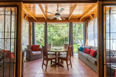 a living room with a table and a couch at Cozy Beach Casita - 4 Min Walk to the Beach in Nosara