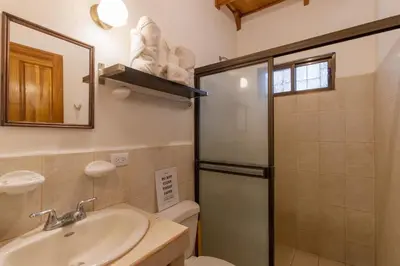 a bathroom with a toilet and a sink and a shower at Cozy Beach Casita - 4 Min Walk to the Beach in Nosara