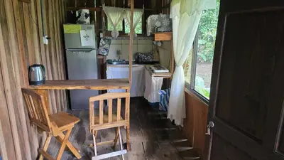 a kitchen with a wooden table and a refrigerator at Landscape-Cabaña Summer-Full Equipada in La Cruz