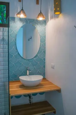 a bathroom with a sink and a mirror at Casa Yami Lodge in Fortuna