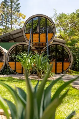 a building with three surfboards in a yard at Pipe House Playa Grande in Playa Grande