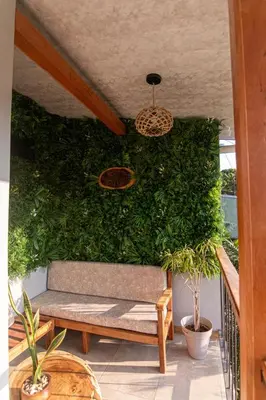 a green wall with a bench and plants at 1968house in Monteverde Costa Rica