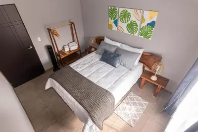 a bedroom with a bed and a mirror at 1968house in Monteverde Costa Rica