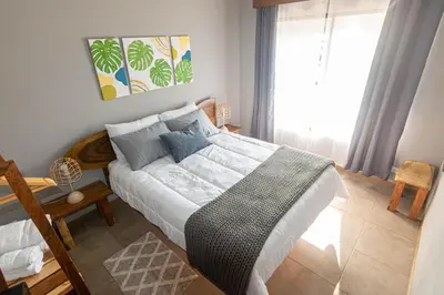 a bedroom with a bed and a large window at 1968house in Monteverde Costa Rica