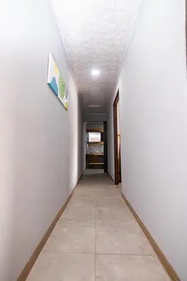 a long hallway with a room with a hallway at 1968house in Monteverde Costa Rica