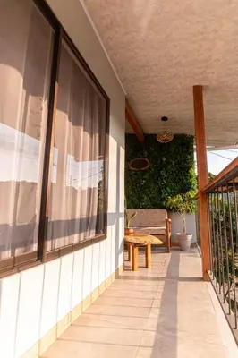 a porch of a house with a bench on it at 1968house in Monteverde Costa Rica