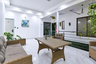 a living room with a wooden table and chairs at Apartaestudios La capital in San José