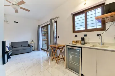a kitchen and living room with a couch and a table at Apartaestudios La capital in San José
