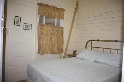 a bedroom with a bed and a window at Casa Amarilla San Carlos in Venecia