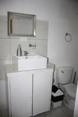 a bathroom with a white sink and a toilet at Casa Amarilla San Carlos in Venecia