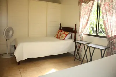 a small bedroom with a bed and a window at Casa Amarilla San Carlos in Venecia