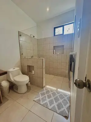 a bathroom with a toilet and a shower at Cozy Cottage Hilltop near Conchal - Casa Vala in Matapalo