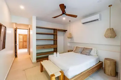 a bedroom with a bed and a ceiling fan at Hermosa Palms, Casa Lorenzo Beach Front Club House in Playa Hermosa