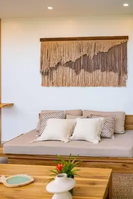 a bed with pillows on it in a room at Hermosa Palms, Casa Lorenzo Beach Front Club House in Playa Hermosa