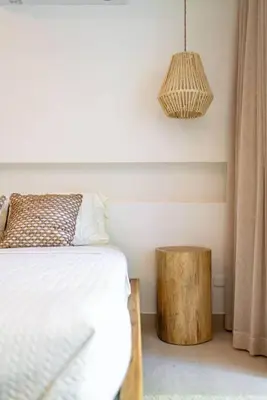 a bedroom with a bed and a wooden stump table at Hermosa Palms, Casa Lorenzo Beach Front Club House in Playa Hermosa