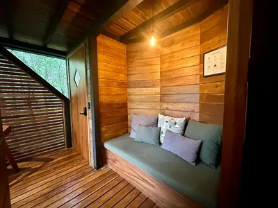 a sauna with a bench in a wooden room at NATURAVE - Into the woods - Mountain cabins in Monteverde Costa Rica
