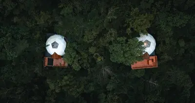 an overhead view of three buildings and trees at NATURAVE - Into the woods - Mountain cabins in Monteverde Costa Rica