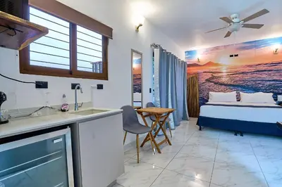 a kitchen and a bedroom with a bed and a sink at Apartaestudio La Capital in San José