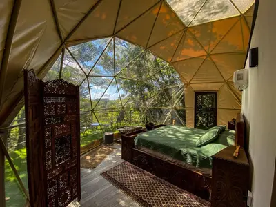 a room with a bed inside of a tent at Way To Heaven Glamping in Monteverde Costa Rica