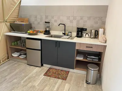 a small kitchen with a sink and a counter at Way To Heaven Glamping in Monteverde Costa Rica