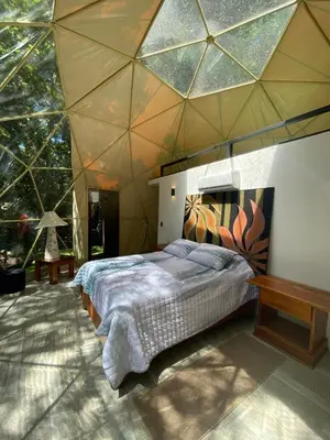 a bedroom with a large bed in a tent at Way To Heaven Glamping in Monteverde Costa Rica