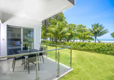 an open balcony with a view of the ocean at Beachfront Condo - your Oasis with pool and Wi-Fi in Bejuco