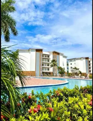 a view of a swimming pool in a resort at Beachfront Condo - your Oasis with pool and Wi-Fi in Bejuco