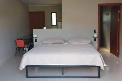 a bedroom with a large bed with a white blanket at Cala-Ranch Suites - Dream in Quesada