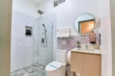 a bathroom with a shower and a toilet and a sink at Apartaestudios La capital in San José