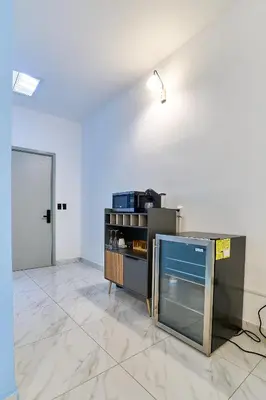 a room with a counter and a light on a wall at Apartaestudios La capital in San José